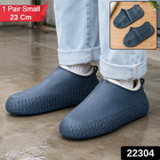 A person wears navy blue silicone shoe covers over their shoes, standing on a wet surface, with product details in the