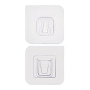 Adhesive wall hooks holding various kitchen utensils, showcasing their versatile use.