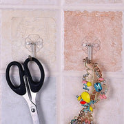 The full 100-pack of multipurpose stainless steel adhesive wall hooks, ready for use.