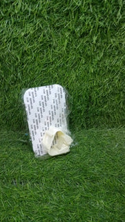 The self-adhesive mop holder securely gripping a broom handle on a wall.
