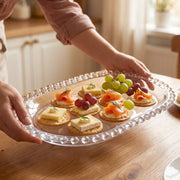 Crystal clear glass platter with beaded rim for table serving